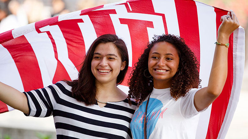 Two students holding an IU flag